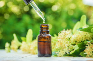 linden extract and flowers in a small bottle. Selective focus.